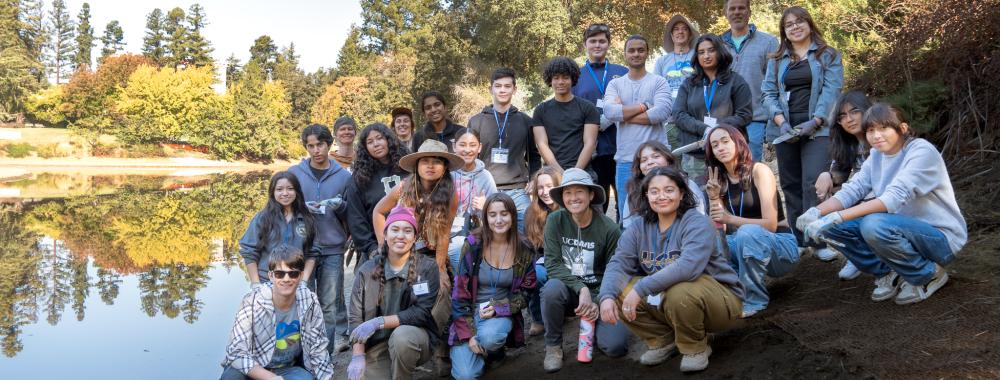 A group of volunteers pose on the banks of the Arboretum Waterway