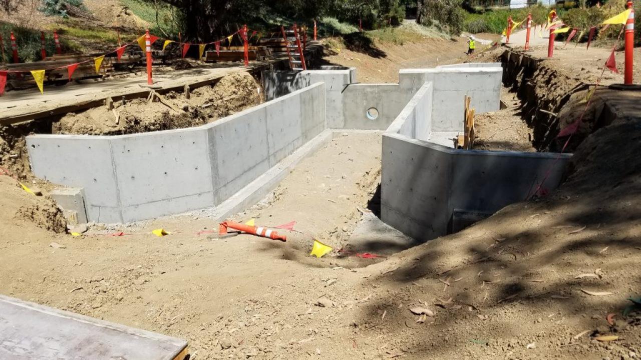 The first of five weirs in this section is complete. The basins on either side of the spillway will become containers for wetland plantings. First weir constructed
