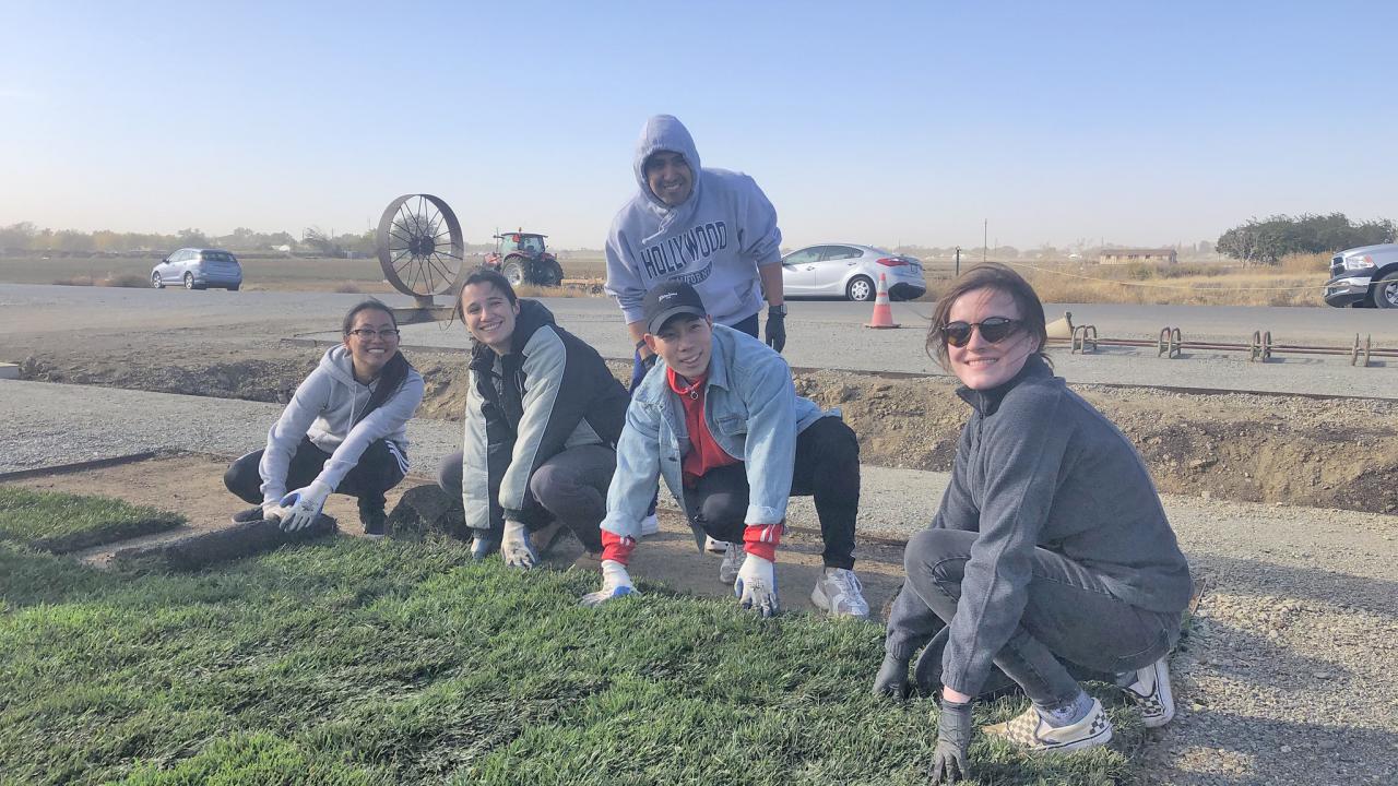 All smiles for the SmartLawn team as they finished up installing turf as part of their research to find the most beneficial and efficient irrigation systems for California homeowners. Image of members of the SmartLawn team installing turf at the UC Davis WCAE.