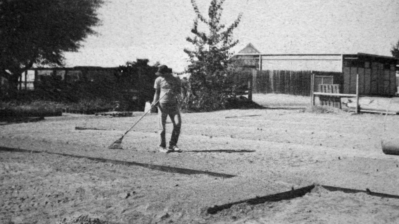 Student worker Joe Gardner rakes gravel in a new growing bed at the Holding Area. The expansion triples the overall size of the nursey. (Photo by Ellen Zagory) Student worker in new growing bed